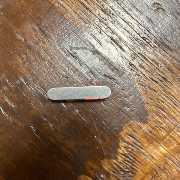 Small metal clip on wooden surface