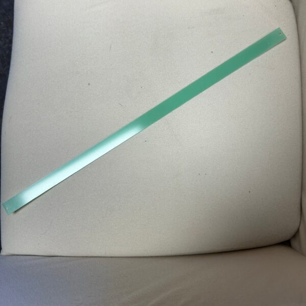 Green ruler on beige fabric