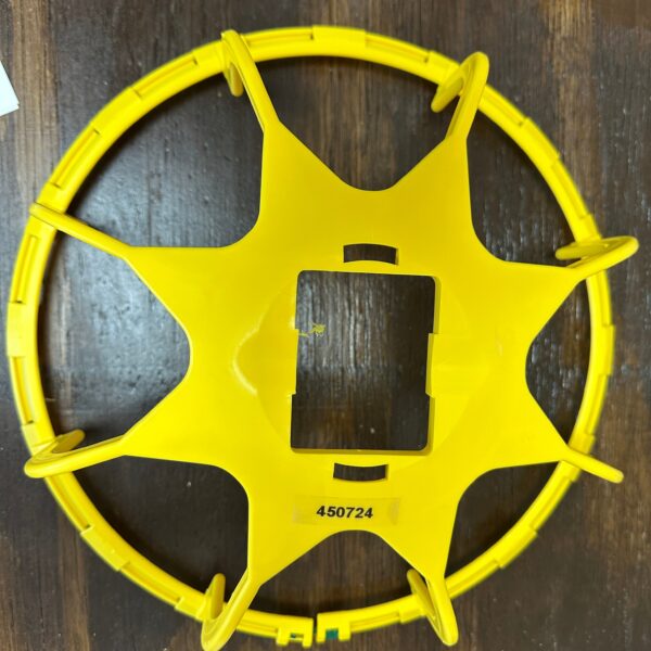 Yellow circular plastic object with spikes