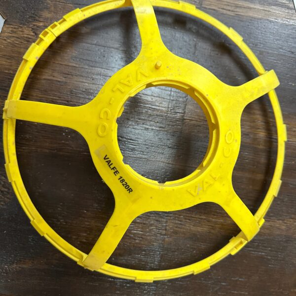 Yellow plastic circular object, Valco