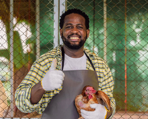 Man holding chicken with thumbs up