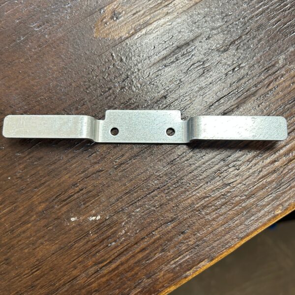 Metal bracket on wooden surface