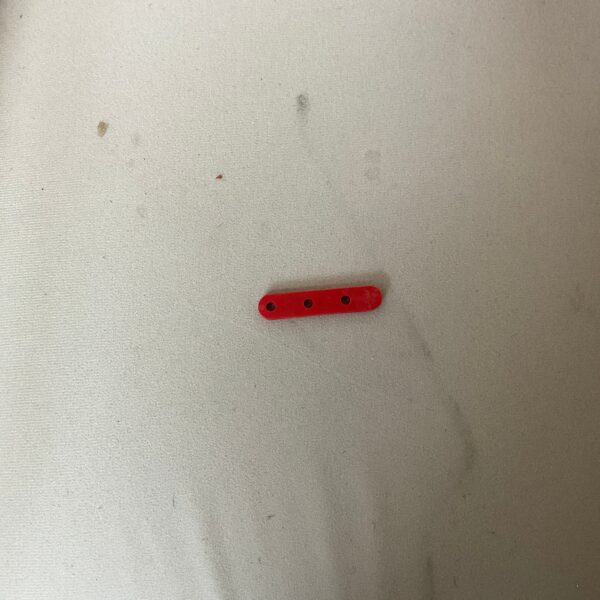 Red object on white surface.